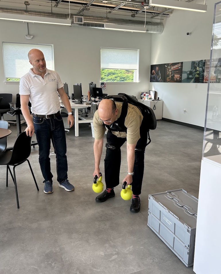 Armin Schmidt, CEO of German Bionic, and editor Eugene Demaitre demonstrate the Apogee exoskeleton.