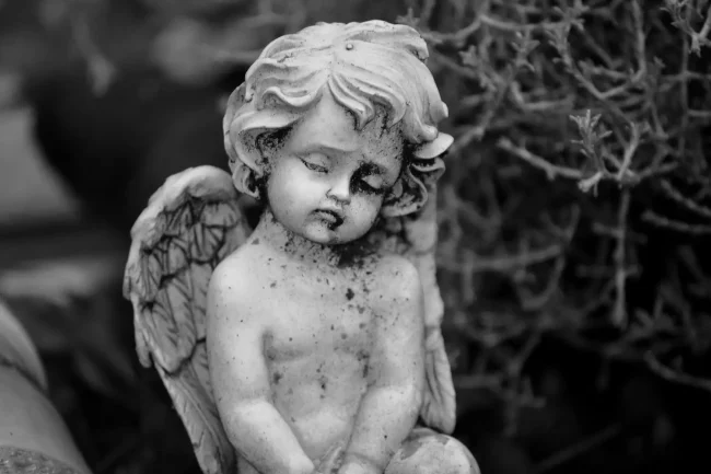 Grayscale photo of a sleepy cherub, by Mario Wallner on Pexels.com